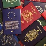 Various colorful international passports spread out.