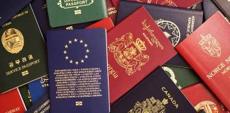 Various colorful international passports spread out.