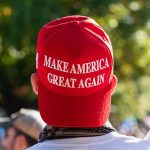 Red Make America Great Again hat on person's head.