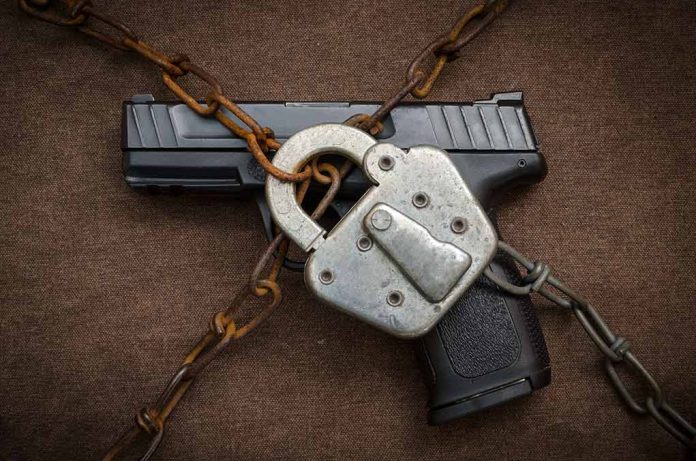339173702 featured image Gun secured with chains and padlock on fabric