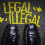 Black shoes facing legal illegal arrows on pavement