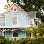Light blue Victorian house with white trim and porch.