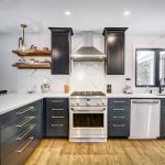 Modern kitchen with black cabinets and stainless appliances.