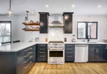 Modern kitchen with black cabinets and stainless appliances.