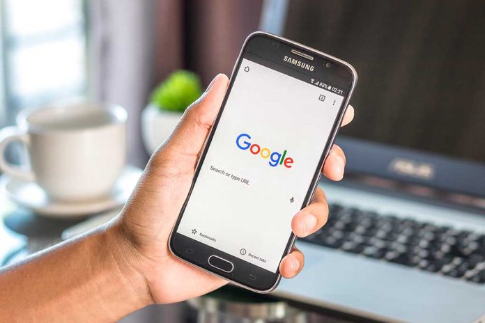 Hand holding smartphone with Google search page