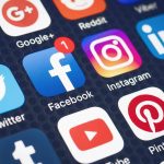 Social media app icons on mobile screen display