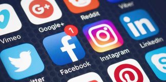 Social media app icons on mobile screen display