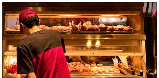 Person in red shirt at fried chicken counter