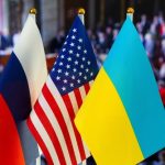 Russian American Ukrainian flags displayed together indoors
