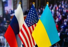Russian American Ukrainian flags displayed together indoors