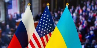 Russian American Ukrainian flags displayed together indoors