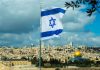 Israeli flag flying over Jerusalem cityscape and Dome.