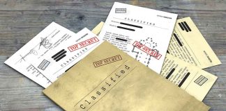 Classified documents with Top Secret stamps on wooden surface