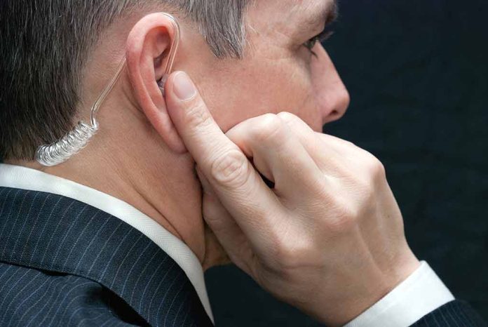 Man wearing an earpiece touching his ear