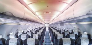 Empty airplane cabin with rows of seats