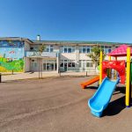 Colorful playground slide in front of a building