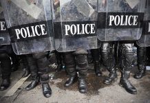 Police officers in riot gear holding shields