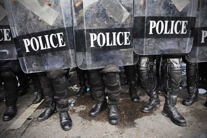 Police officers in riot gear holding shields