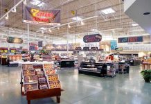Supermarket interior with various food sections and displays.