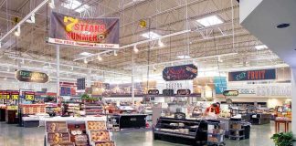 Supermarket interior with various food sections and displays.