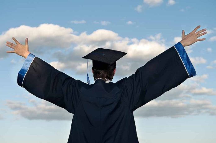 55937464 featured image Graduate in cap and gown celebrates under cloudy sky