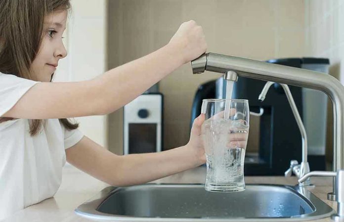 1742845301 Girl filling glass with water from kitchen faucet