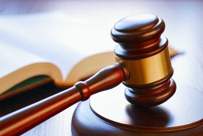Gavel resting on sounding block beside open book
