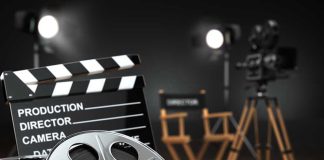 Movie set with film reels and clapperboard