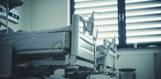 Empty hospital beds by a window