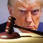 Gavel in front of a serious man's face