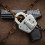 Pistol locked with chains and a padlock