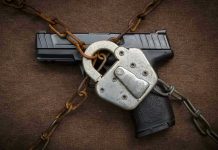 Pistol locked with chains and a padlock