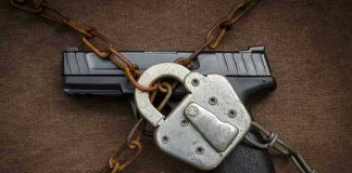 Pistol locked with chains and a padlock