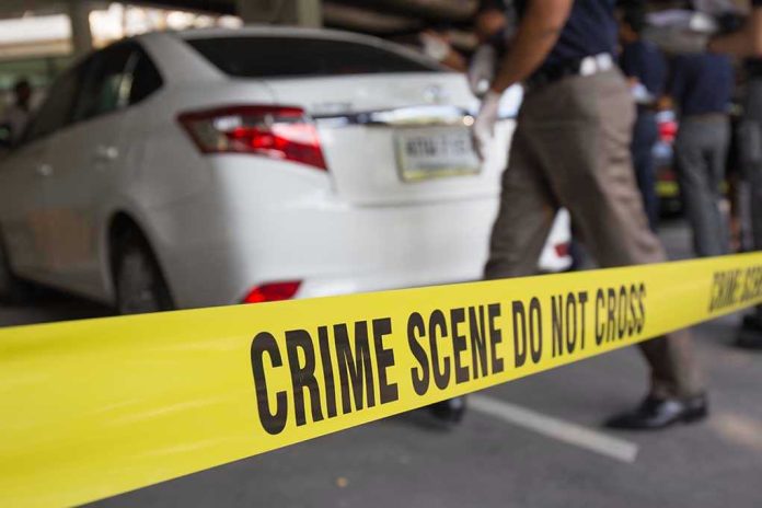 351048443 Crime scene tape blocking off white sedan