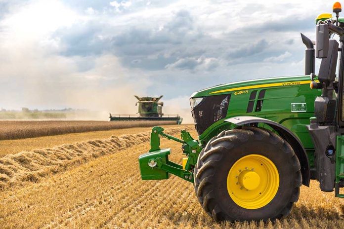 740872495 A green tractor in a wheat field
