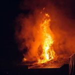 Toxic Smoke Chokes Midwest—Lawmakers Fume Building engulfed in large flames at night