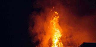 Building engulfed in large flames at night