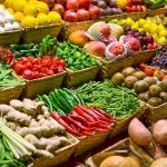 A vibrant display of assorted fruits and vegetables in baskets at a market