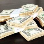 Woke CEO PROFITS $6.68 Million During Cracker Barrel DISASTER Stacks of bundled cash on a wooden table