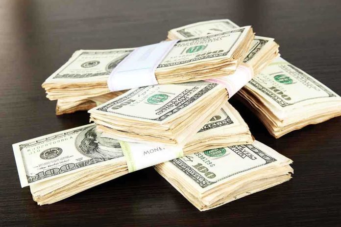 Stacks of bundled cash on a wooden table