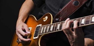 Close-up of a musicians hands playing an electric guitar