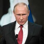 Russia’s 600-Drone MASSACRE – Citizens TARGETED! Person speaking into a microphone, official setting.