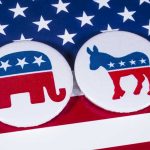 Unexpected Poll Twist Stuns – EARLY Mid-Term Numbers! Republican elephant and Democrat donkey on American flag.
