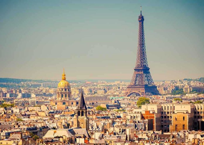 A panoramic view of Paris featuring the Eiffel Tower and a golden dome