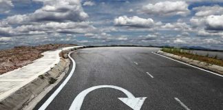 Curved road with a U-turn arrow marking.