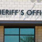 Sheriffs Office sign on brick building faade.