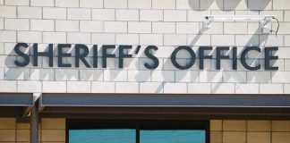 Sheriffs Office sign on brick building faade.