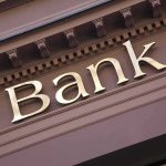 Bank Secrecy ACT Under FIRE – FINALLY! Gold bank sign on building facade