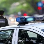 Mayor BRUTALLY Stabbed—Daughter In Custody! Police car and officer on a city street.