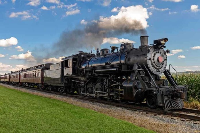 A vintage steam locomotive pulling passenger cars on a railway track